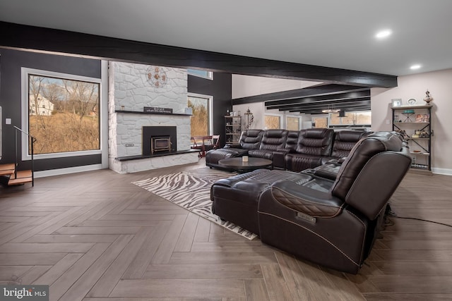 living area featuring beam ceiling, baseboards, a fireplace, and recessed lighting