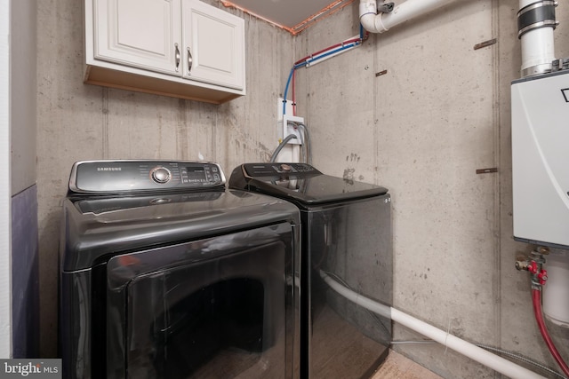 laundry area with cabinet space and separate washer and dryer