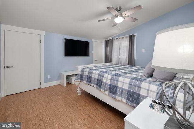 bedroom featuring a ceiling fan, baseboards, and lofted ceiling