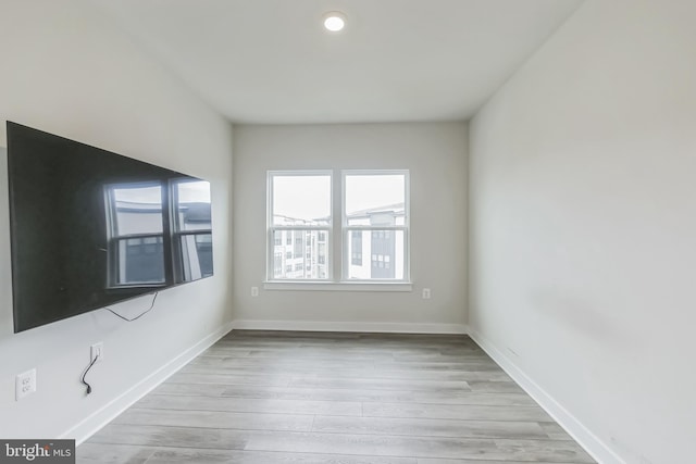 unfurnished room featuring baseboards and wood finished floors
