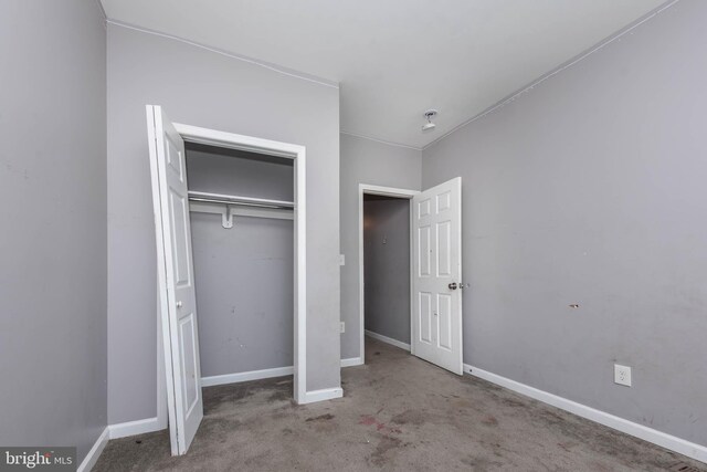 2110 E Hoffman St, Baltimore, MD 21213 - unfurnished bedroom featuring baseboards and a closet