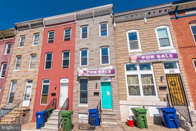 2110 E Hoffman St, Baltimore, MD 21213 - view of property featuring stone siding and entry steps