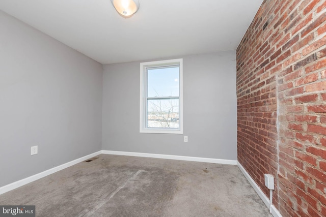 2110 E Hoffman St, Baltimore, MD 21213 - unfurnished room featuring carpet flooring, brick wall, baseboards, and visible vents