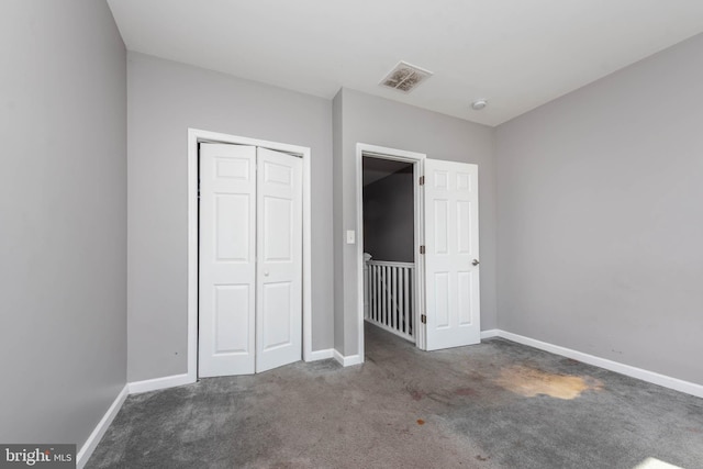 2118 E Hoffman St, Baltimore, MD 21213 - unfurnished bedroom featuring baseboards, visible vents, a closet, and carpet