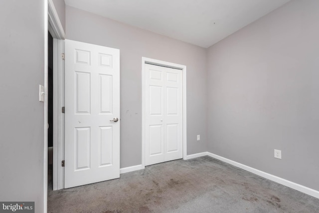 2118 E Hoffman St, Baltimore, MD 21213 - unfurnished bedroom featuring a closet, carpet, and baseboards