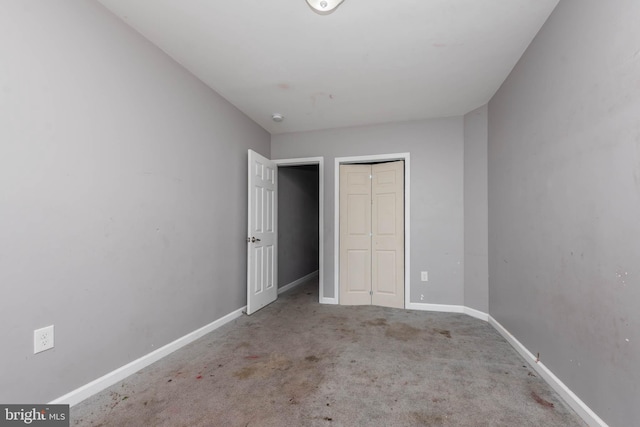2118 E Hoffman St, Baltimore, MD 21213 - unfurnished bedroom with baseboards, carpet floors, and a closet