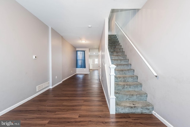 2118 E Hoffman St, Baltimore, MD 21213 - staircase with baseboards, visible vents, and wood finished floors