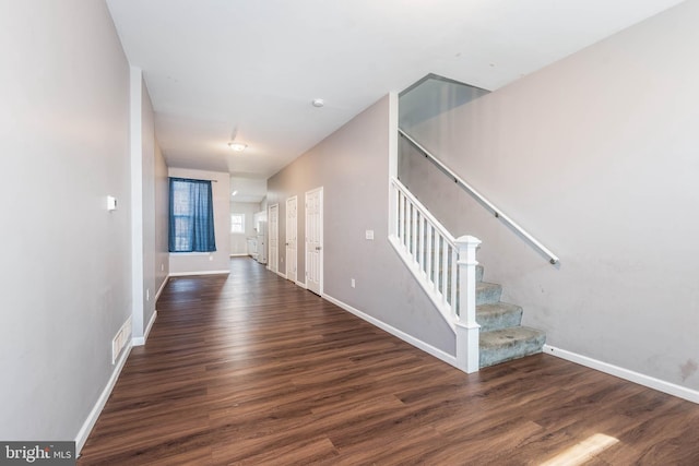 2118 E Hoffman St, Baltimore, MD 21213 - stairway featuring baseboards, visible vents, and wood finished floors