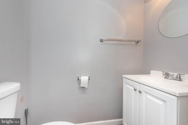 2118 E Hoffman St, Baltimore, MD 21213 - bathroom with toilet, vanity, and baseboards