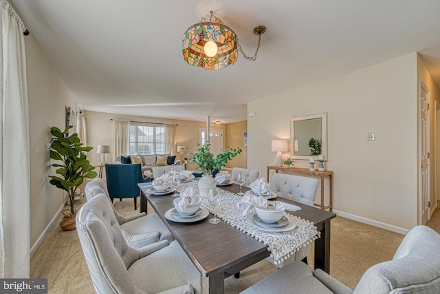 dining room with light carpet and baseboards