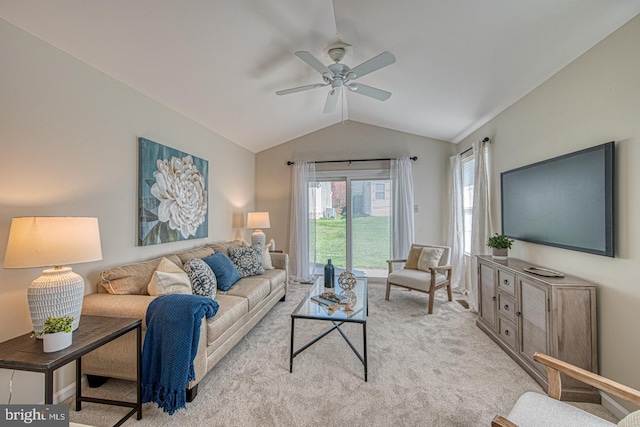 living room featuring ceiling fan, lofted ceiling, and light carpet