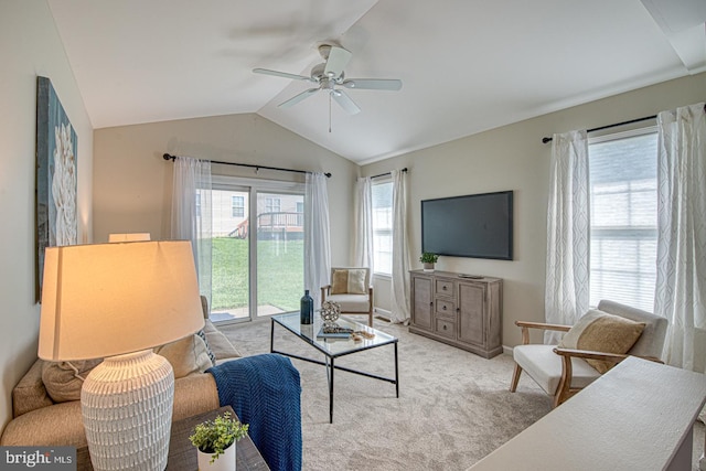 living area featuring a ceiling fan, baseboards, carpet floors, and vaulted ceiling