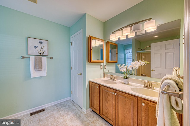 full bath with baseboards, tile patterned flooring, a sink, and visible vents