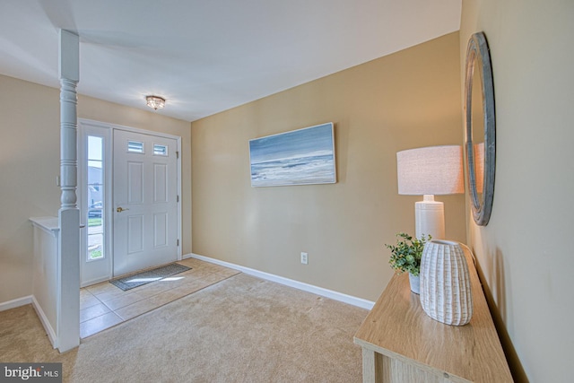 carpeted entrance foyer with baseboards