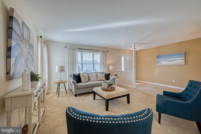 living room with baseboards and light colored carpet