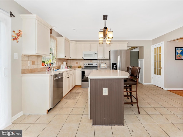kitchen with tasteful backsplash, a breakfast bar, a center island, and stainless steel appliances