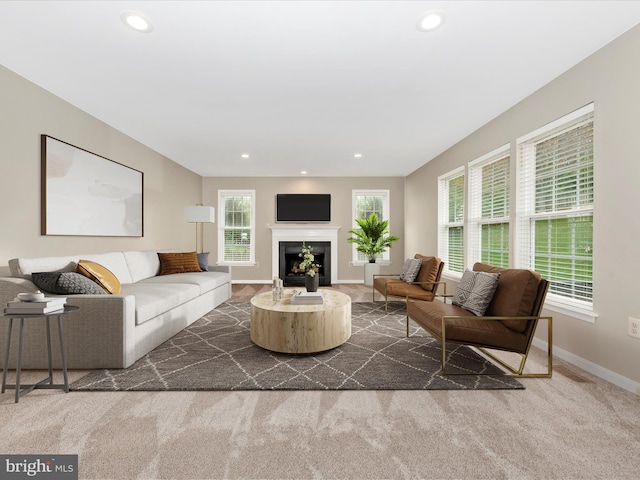 living room with dark carpet, baseboards, recessed lighting, and a fireplace