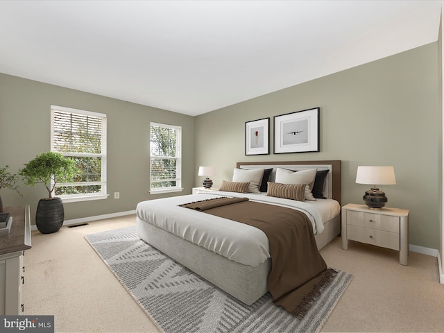 bedroom with visible vents, baseboards, and light colored carpet