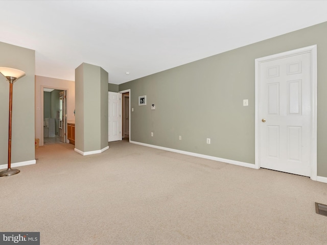 unfurnished living room featuring light colored carpet, baseboards, and visible vents