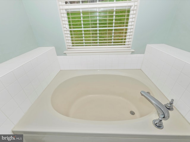 full bath featuring plenty of natural light and a garden tub