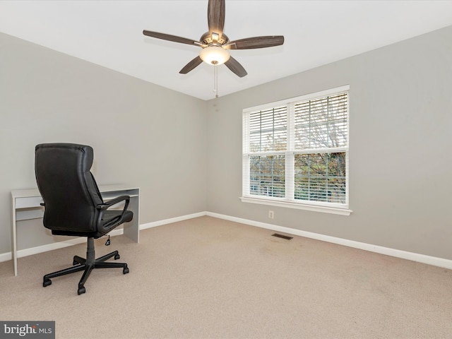 unfurnished office featuring visible vents, baseboards, and carpet floors