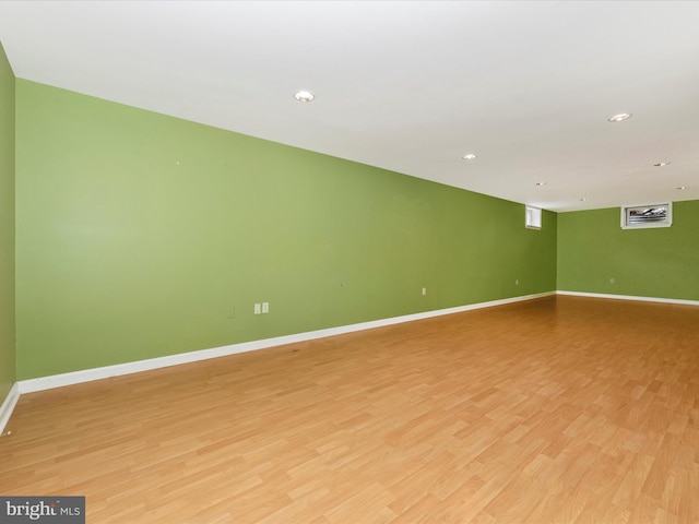 unfurnished room with recessed lighting, light wood-type flooring, and baseboards