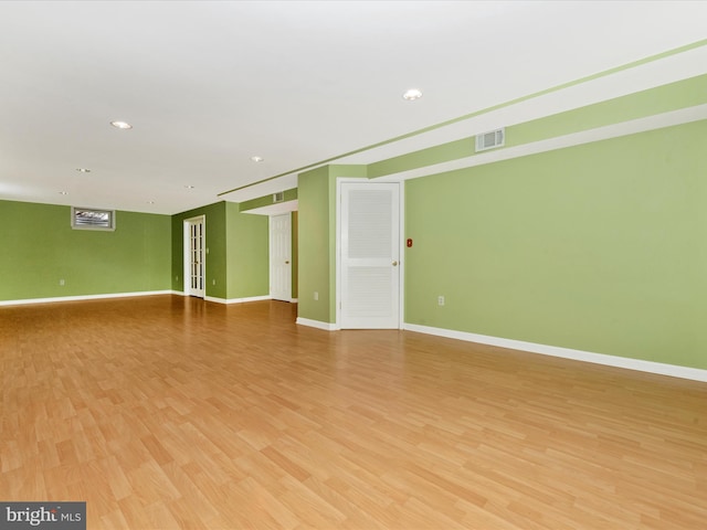 empty room with recessed lighting, visible vents, light wood-type flooring, and baseboards