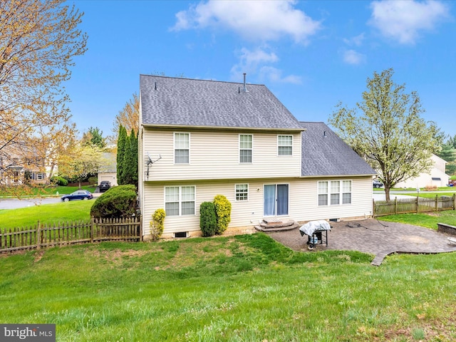 back of house featuring a patio, a yard, and a shingled roof
