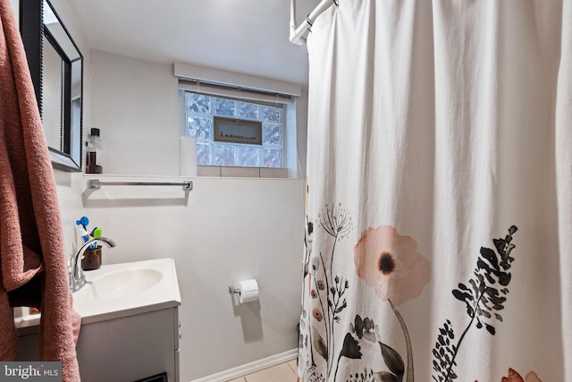 full bath featuring a shower with shower curtain, tile patterned floors, and vanity