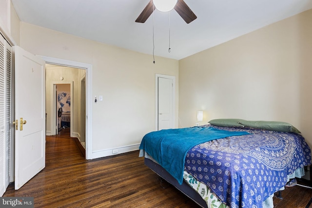 bedroom featuring baseboards, wood finished floors, a closet, and ceiling fan