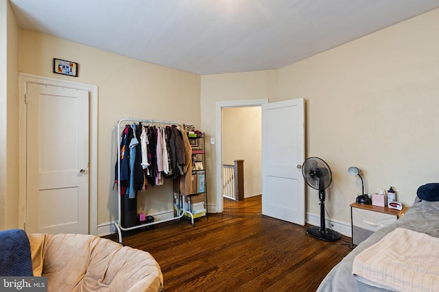 bedroom featuring dark wood-type flooring and baseboards
