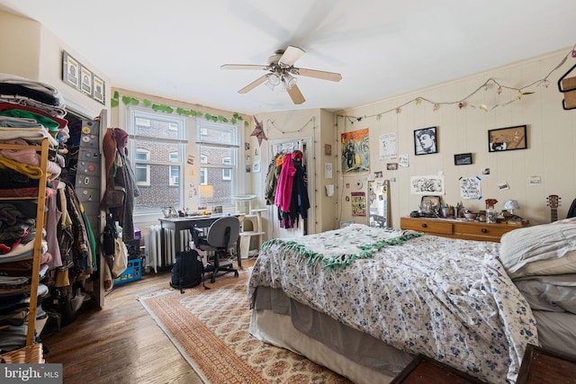 bedroom featuring radiator, wood finished floors, and ceiling fan