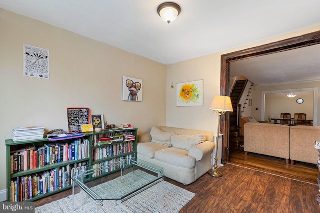 living room with wood finished floors and stairway