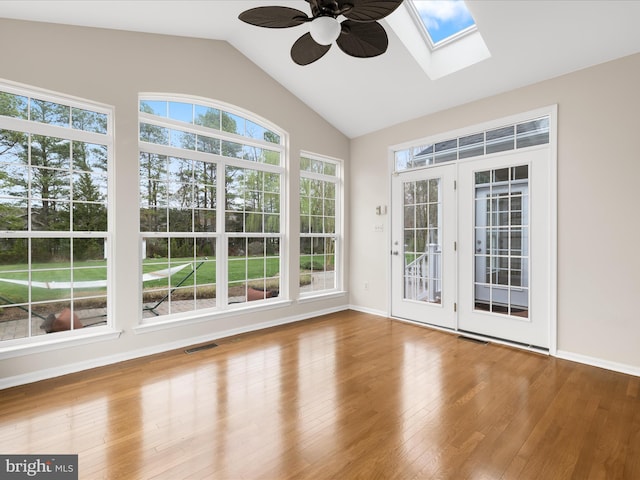 unfurnished sunroom with visible vents and a skylight