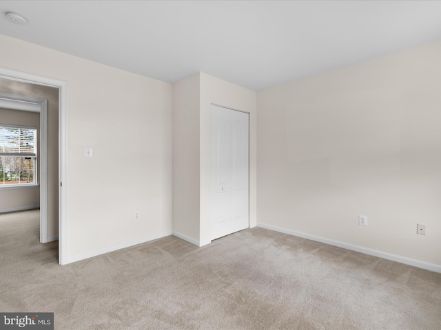 spare room with carpet flooring and baseboards