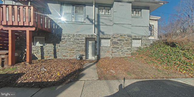 view of side of property with stone siding