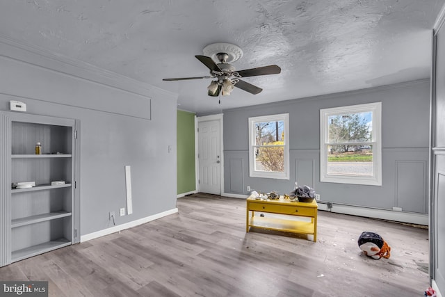 423 Main St, Dorchester, NJ 08316 - interior space featuring ornamental molding, a textured ceiling, a baseboard radiator, built in features, and wood finished floors