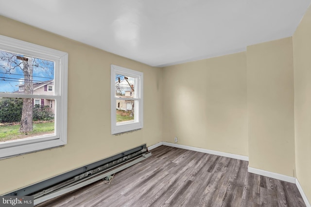 423 Main St, Dorchester, NJ 08316 - empty room featuring baseboards, a wealth of natural light, wood finished floors, and a baseboard radiator