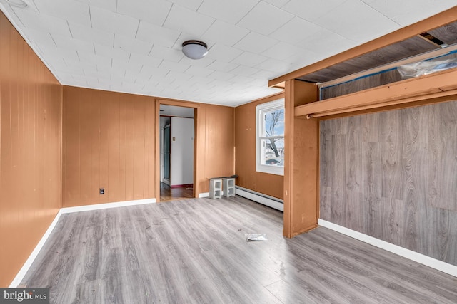 423 Main St, Dorchester, NJ 08316 - interior space with baseboards, wood finished floors, a baseboard heating unit, and wood walls