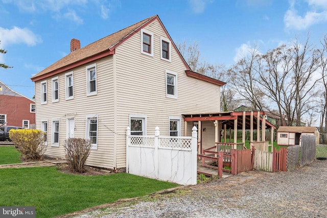 423 Main St, Dorchester, NJ 08316 - exterior space featuring a chimney, an outbuilding, a wooden deck, a storage unit, and a lawn