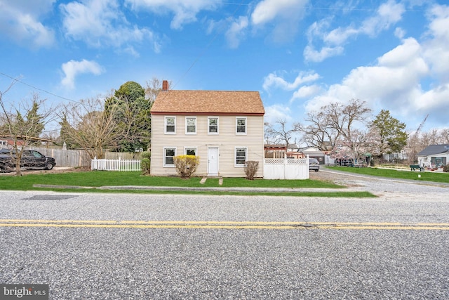 423 Main St, Dorchester, NJ 08316 - view of front of property featuring a front lawn, a chimney, fence, and driveway
