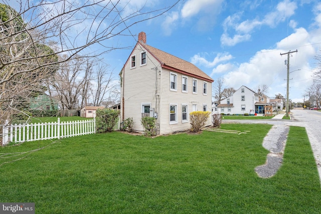423 Main St, Dorchester, NJ 08316 - exterior space featuring a chimney, roof with shingles, fence, and a yard