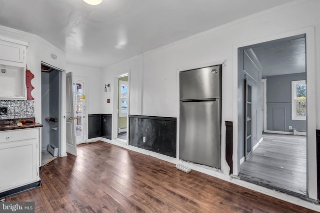 423 Main St, Dorchester, NJ 08316 - kitchen with freestanding refrigerator, dark wood-type flooring, a baseboard radiator, dark countertops, and ornamental molding