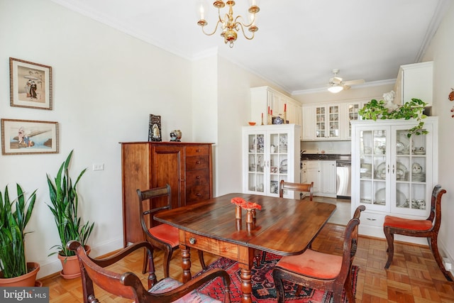 dining area with baseboards, ornamental molding, and ceiling fan with notable chandelier