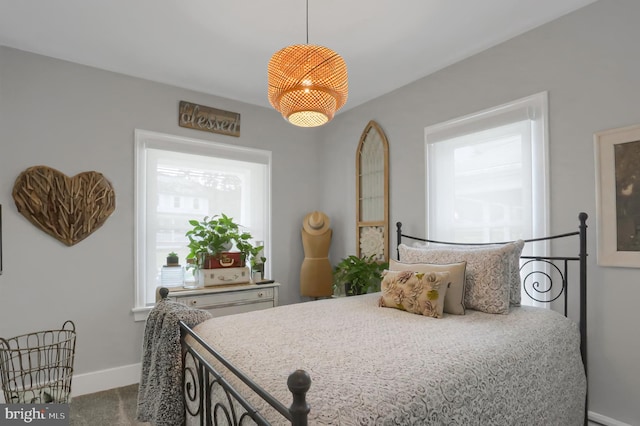 carpeted bedroom featuring baseboards