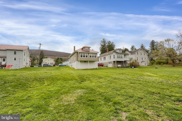 rear view of property featuring a yard