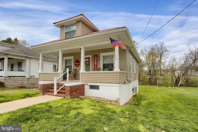 bungalow-style home with a front yard and covered porch