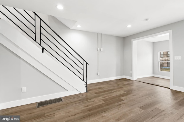 interior space featuring stairs, visible vents, wood finished floors, and recessed lighting