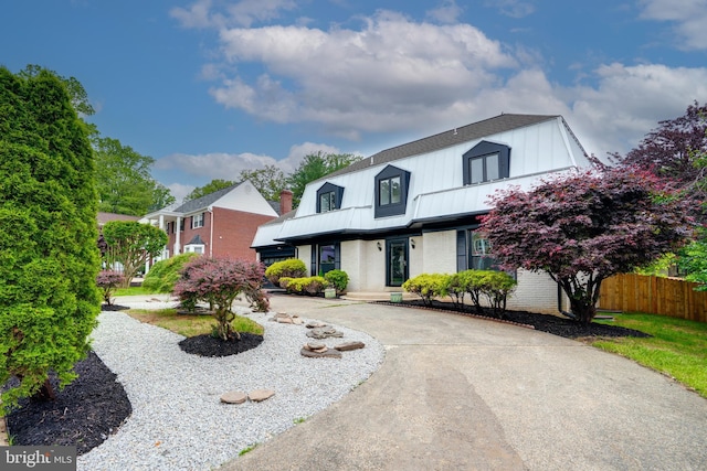 7434 Mason Ln, Falls Church, VA 22042 - view of front of house with fence, metal roof, brick siding, and a standing seam roof