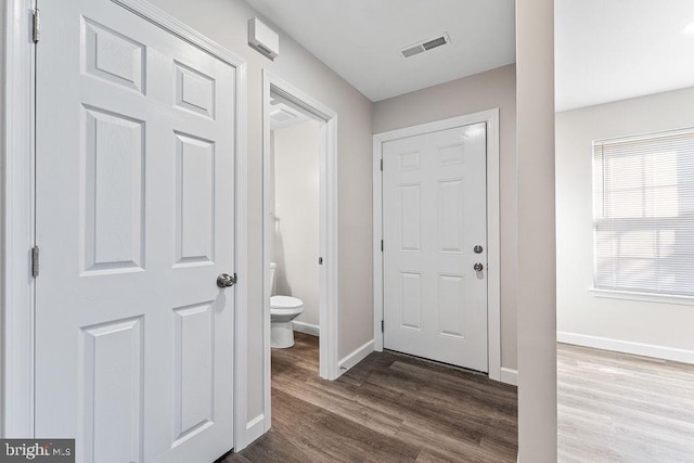 bathroom featuring baseboards, visible vents, toilet, and wood finished floors